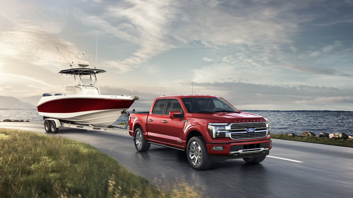 2024 Ford F-150 towing a boat next to a body of water