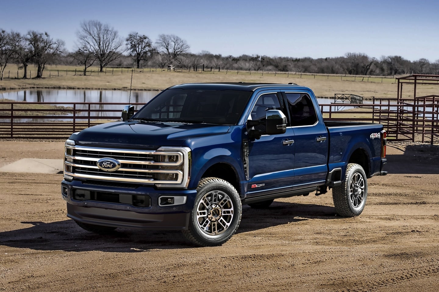 A blue Ford Super Duty parked at a ranch.