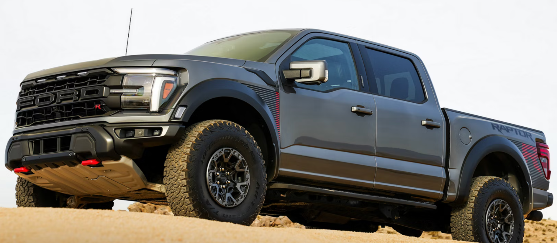 A gray Ford F-150 driving through a desert.