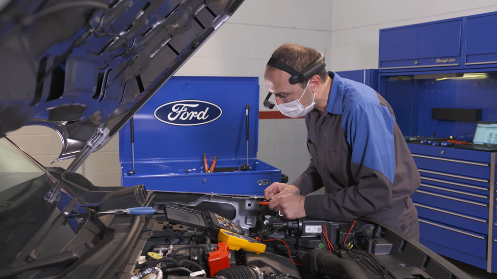 Sign Up with CARFAX for Life for Open Recalls Ford Technician checking Ford Vehicle Engine under the hood