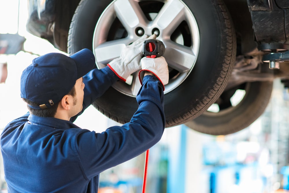 Service tech performing tire service